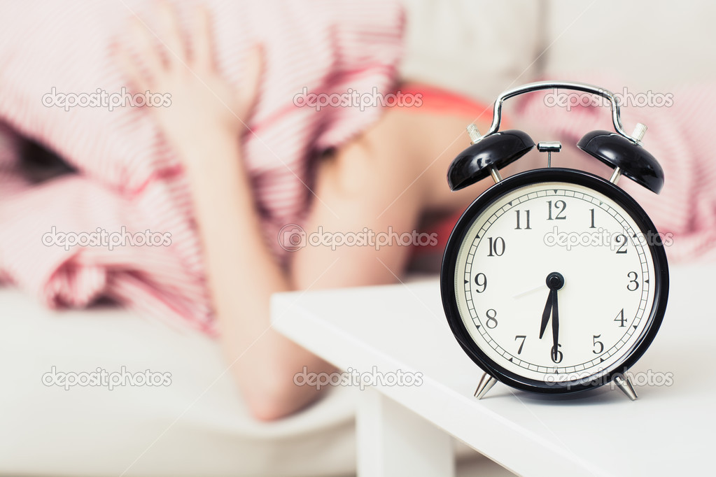 Black alarm clock and woman