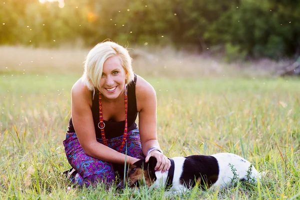 Portrait of a woman with her beautiful dog lying outdoors — Stock Photo, Image