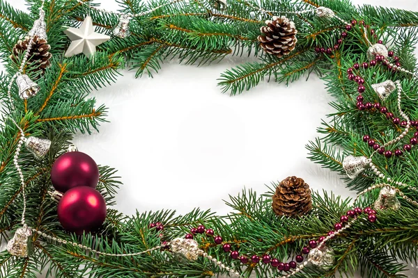 Ramas de pino con adornos navideños en blanco —  Fotos de Stock