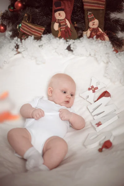 Little baby lying at home in christmas interior — Stock Photo, Image