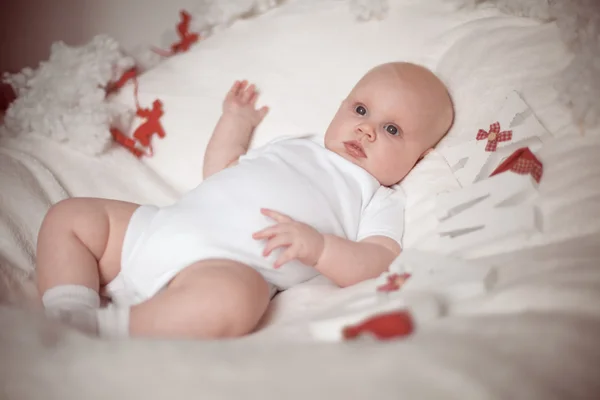 Little baby lying at home in christmas interior — Stock Photo, Image