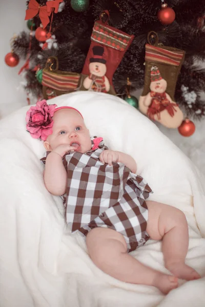 Little baby lying at home in christmas interior — Stock Photo, Image