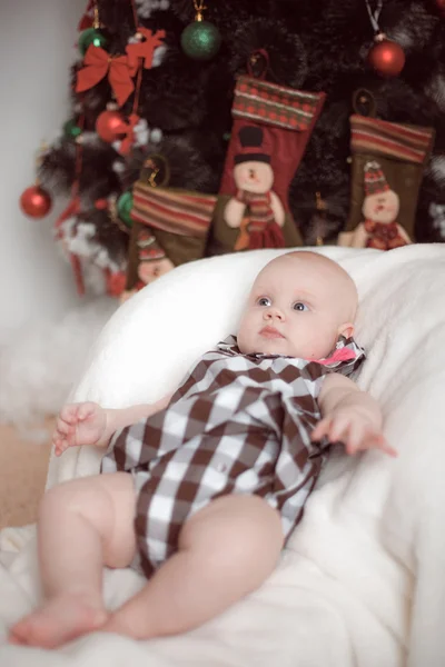 Little baby lying at home in christmas interior — Stock Photo, Image