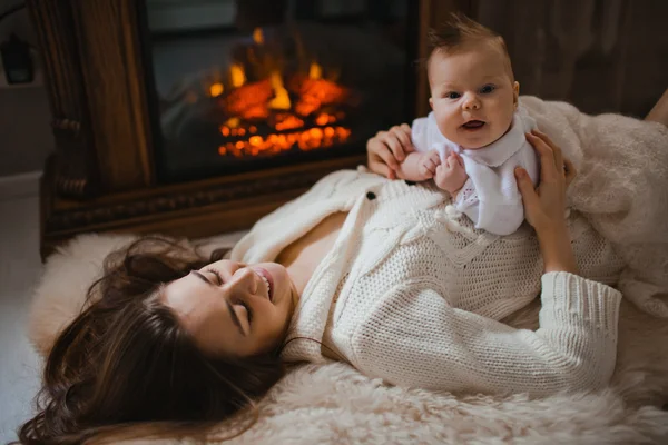 Young mother holding her newborn baby — Stock Photo, Image