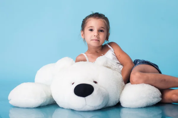 Cute little girl on blue background — Stock Photo, Image