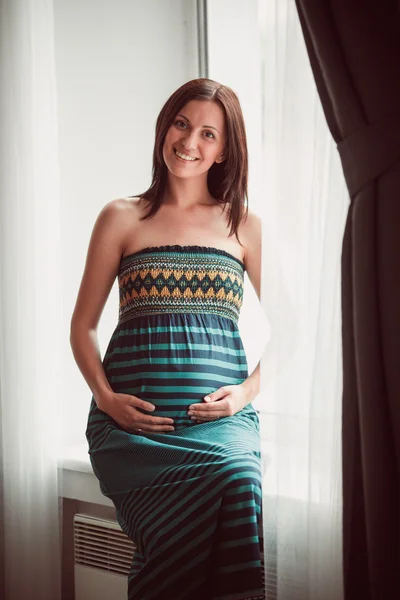 Pregnant woman put her hands on belly — Stock Photo, Image