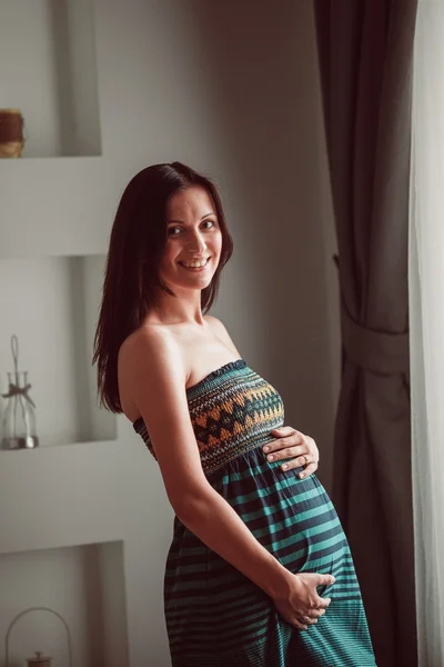 Pregnant woman put her hands on belly — Stock Photo, Image