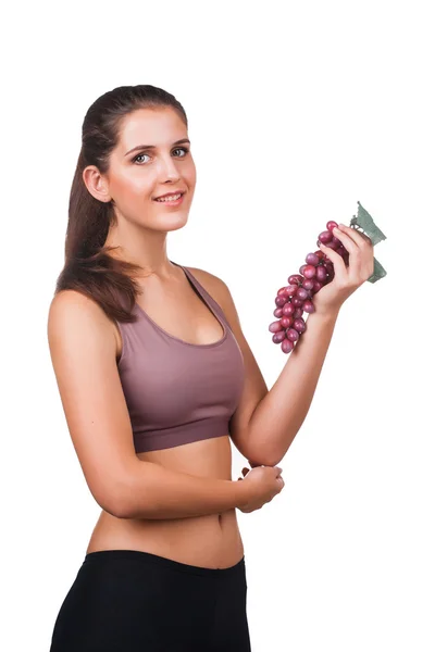 Beautiful woman holding a bunch of grapes — Stock Photo, Image