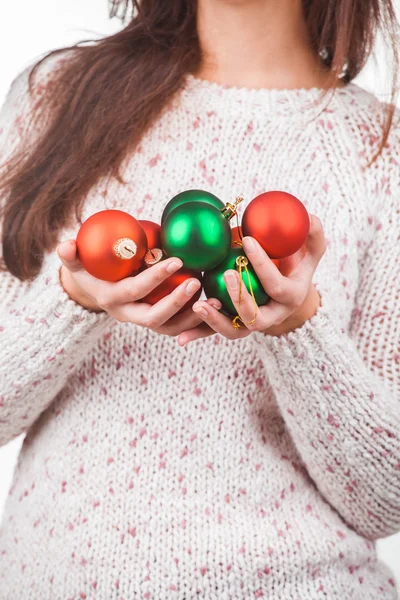 Portrait of a young girl in white sweater with christmas balls — Zdjęcie stockowe