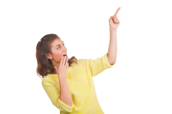 Young woman pointing at something on white background — Stock Photo, Image