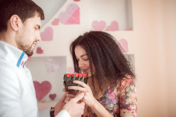 Couple with flowers in soil — Stock Photo, Image