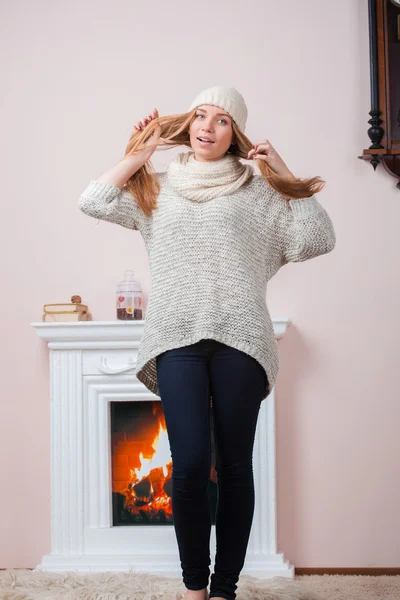 Blonde girl near fireplace — Stock Photo, Image