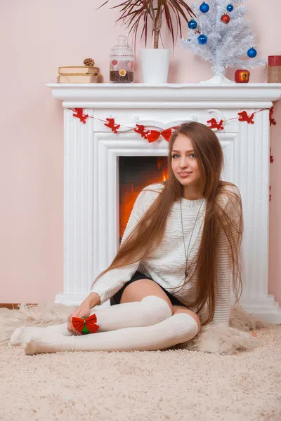 Girl sitting beside the fireplace — Stock Photo, Image