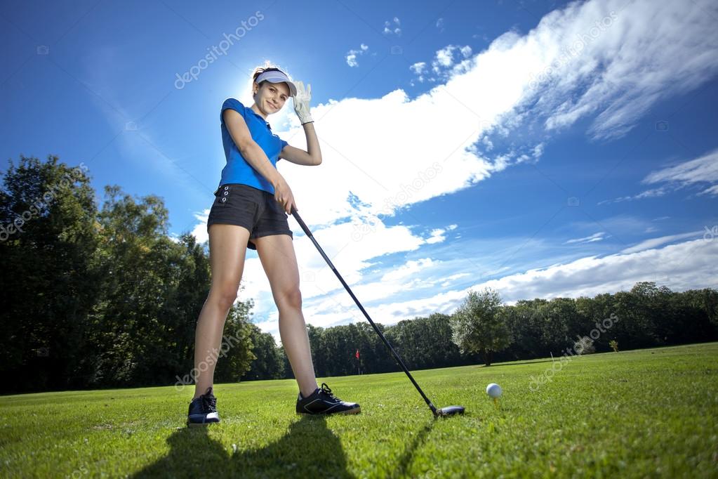 Woman playing golf on field