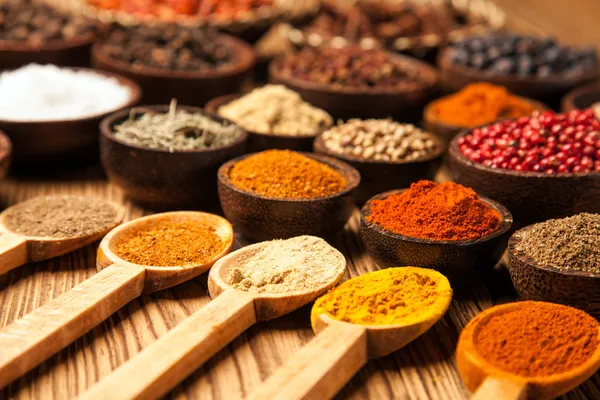 Spices and herbs in wooden bowls. Royalty Free Stock Images