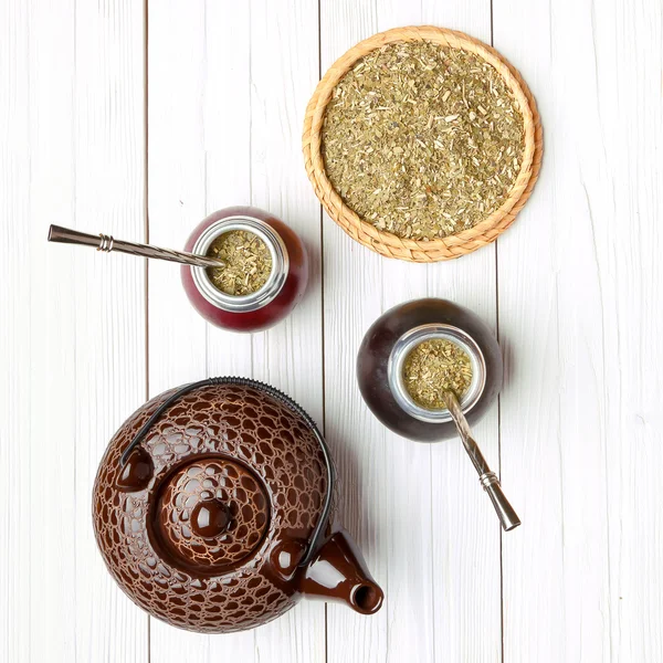 Yerba mate and calabashes on a light wooden background, top view — Stock Photo, Image