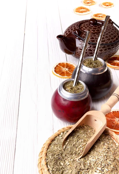 Hot mate in calabashes and set for its brewing on a light wooden — Stock Photo, Image