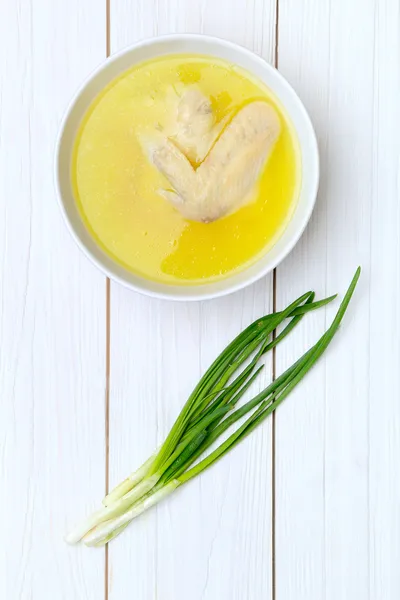 Chicken broth and green onions — Stock Photo, Image