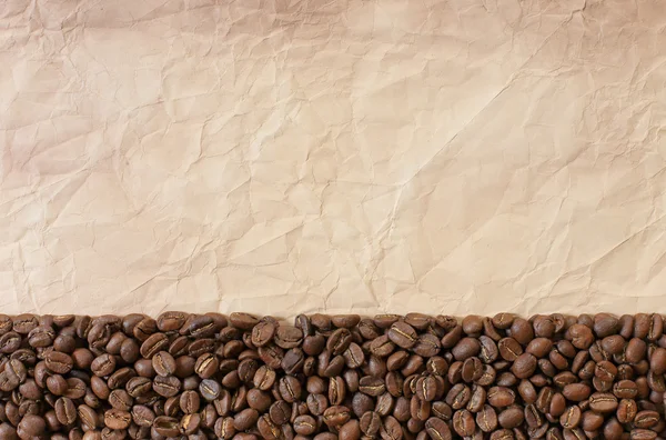 Background from coffee beans and old paper — Stock Photo, Image