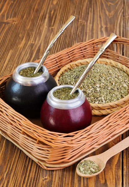 Yerba mate and mate in calabash on a wicker tray — Stock Photo, Image