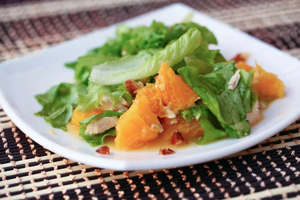 Salad with chicken, oranges, honey and almonds — Stock Photo, Image