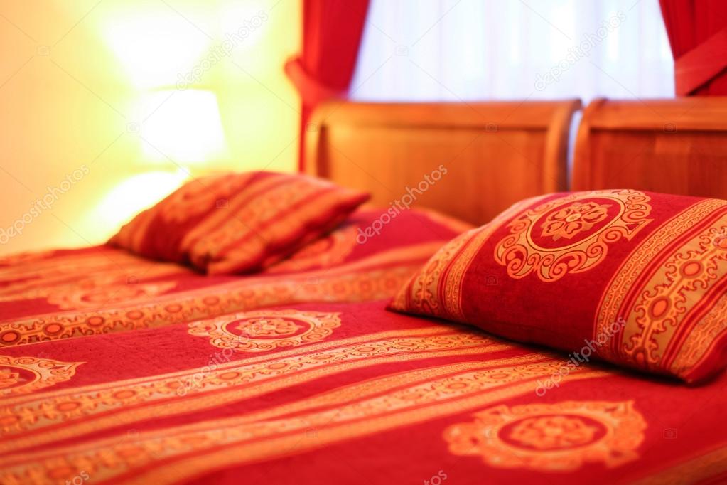 Pillows and double bed in interior of modern hotel