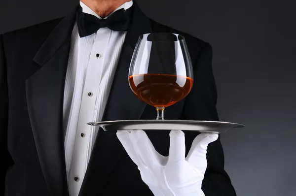 Garson ile tepsi üzerinde bir yudum konyak