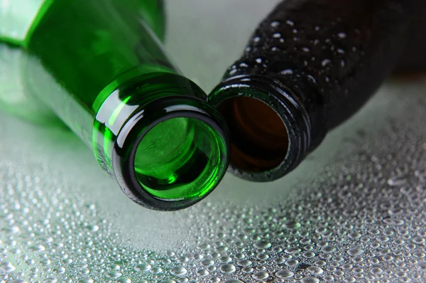 Closeup of two beer bottles on Wet Surface — Stock Photo, Image