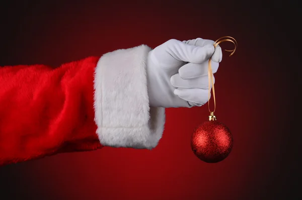Santa ruku hospodářství červený ornament — Stock fotografie