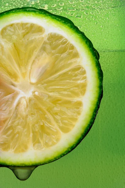 Lime with drip and Green Background — Stock Photo, Image