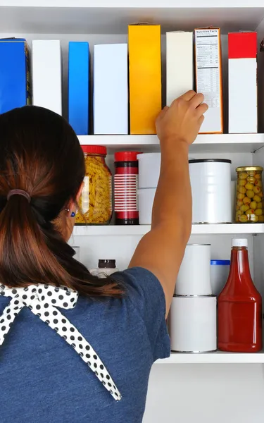 Woman Reaching Into Pantry — Stock Photo, Image