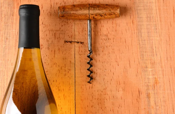 Chardonnay Bottle and Corkscrew on Wood Background — Stock Photo, Image