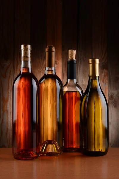 Vin flaskor mot trä bakgrund — Stockfoto