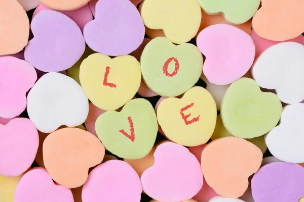 Candy Hearts Macro with LOVE Spelled Out — стоковое фото