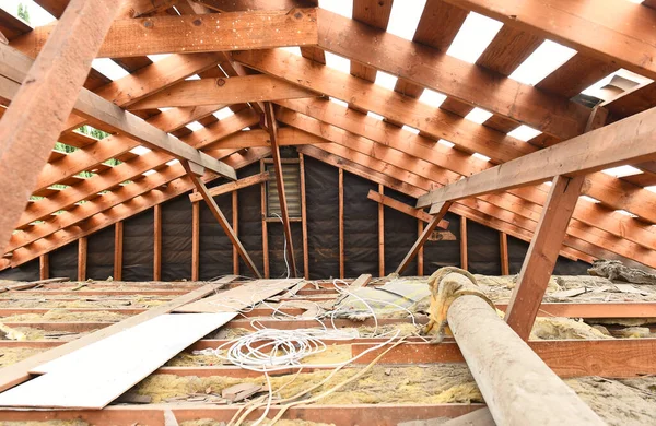 Inside a home attic that has had the wood shake shingles removed and ready for a new roof.