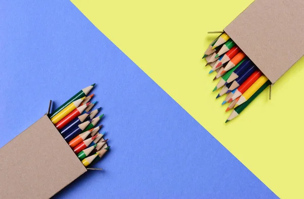 High Angle Shot Boxes Multi Colored Pencils Blue Yellow Background — Fotografia de Stock