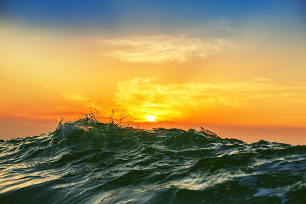 Sunrise and shining waves in ocean