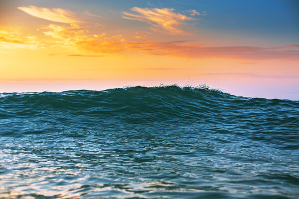 Sunrise light shining on ocean wave