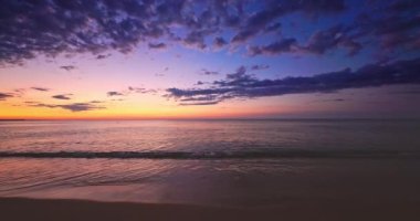 Beautiful ocean beach sunrise and splashing waves on the sea sand, 4K video of nature landscape, seascape view