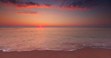 Beautiful ocean beach sunrise and splashing waves on the sea sand, 4K video of nature landscape, seascape view