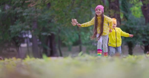 Happy Kids Laughing Girl Boy Playing Outdoor Colorful Fallen Leaves — Stock video