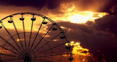 Ferris Wheel in amusement park and  scenic sunset clouds in sky, 4k video