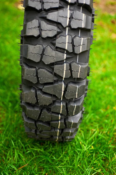 Tire at green grass — Stock Photo, Image
