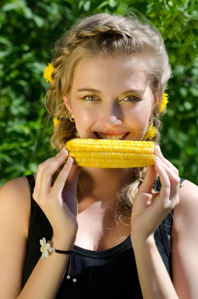 Woman eating corn-cob Stock Image