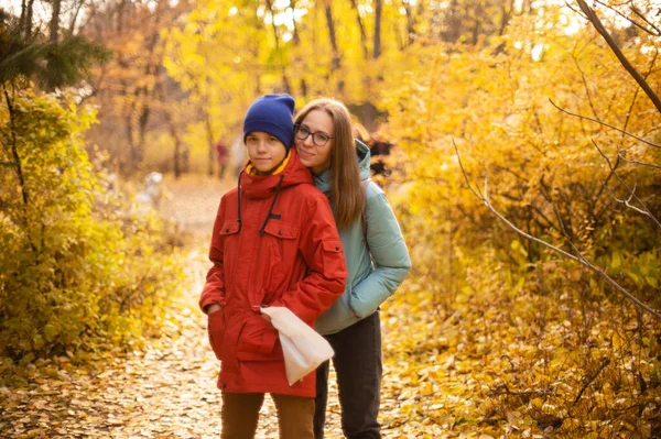 Autumn portrait of happy beautiful woman with her son — Stock Photo, Image