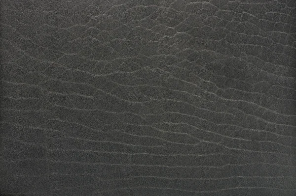 フラットグレーの革のテクスチャマクロを閉じるビュー 暗い肌の背景 — ストック写真