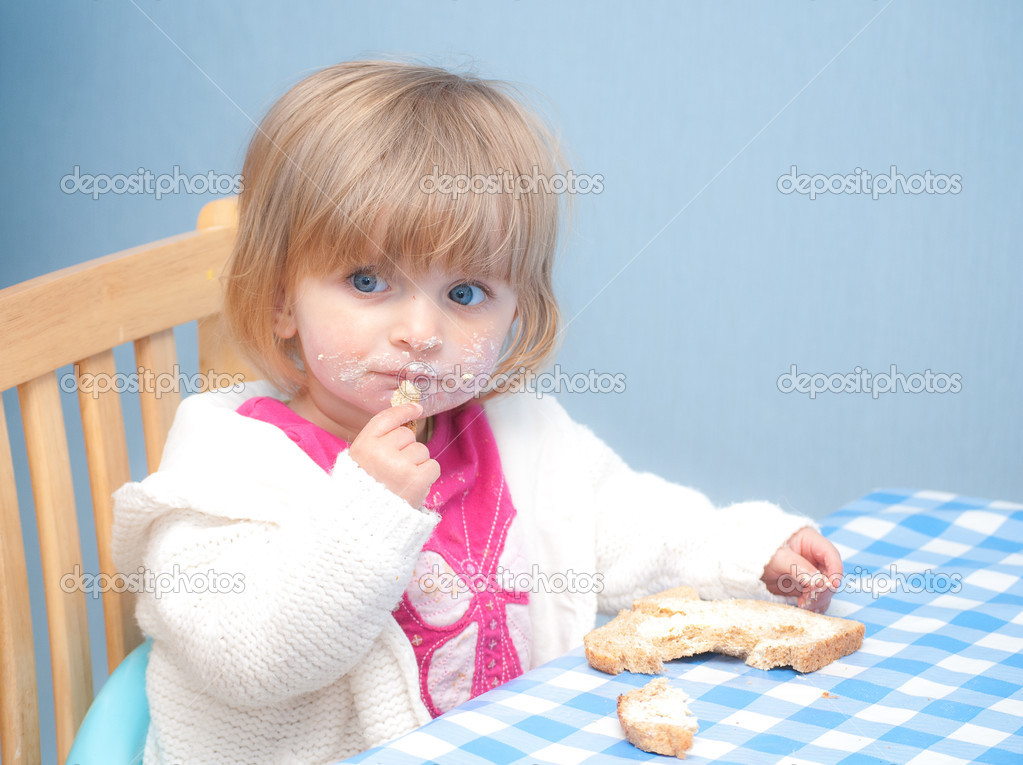 Baby eating bread and butter