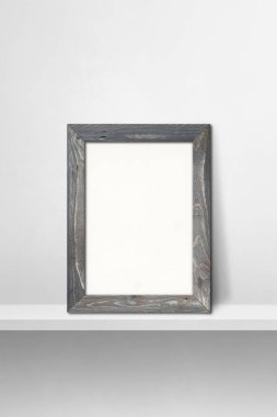 Ahşap çerçeve beyaz bir rafa yaslanıyor. 3 boyutlu illüstrasyon. Boş model şablonu. Dikey arkaplan