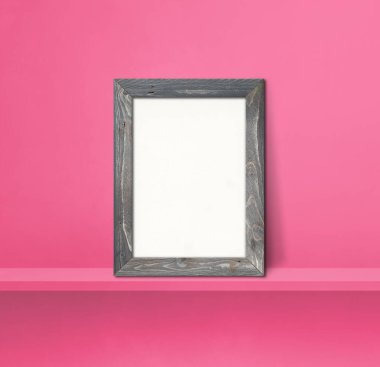 Pembe bir rafa yaslanmış ahşap resim çerçevesi. 3 boyutlu illüstrasyon. Boş model şablonu. Kare arkaplan