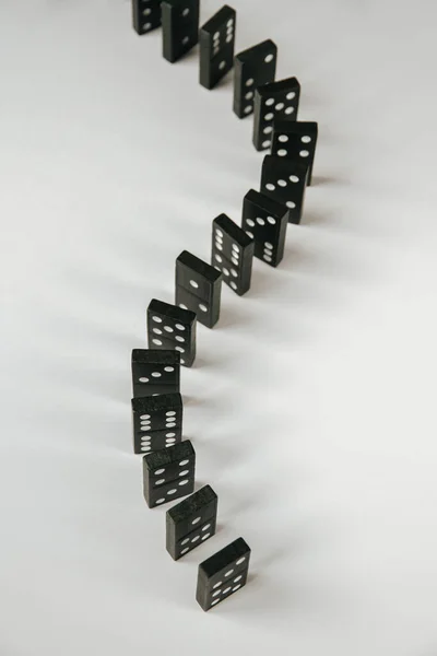 Black Dominoes Chain White Table Background Domino Effect Concept — Stock Photo, Image